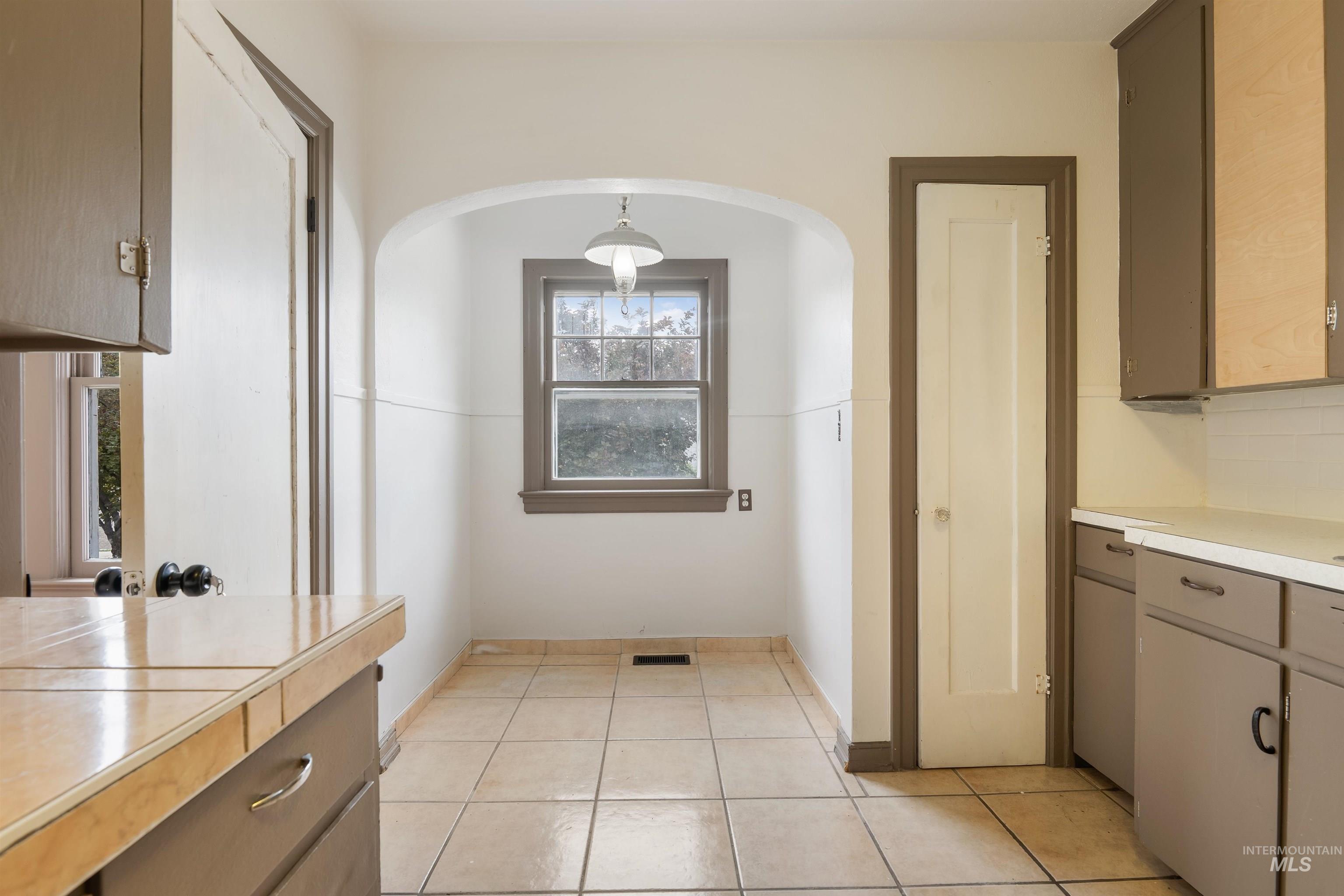 191 Southwest 5th Avenue Ontario, OR 97914 - Photo 19 of 50 Kitchen with light countertops, light tile patterned floors, and decorative backsplash