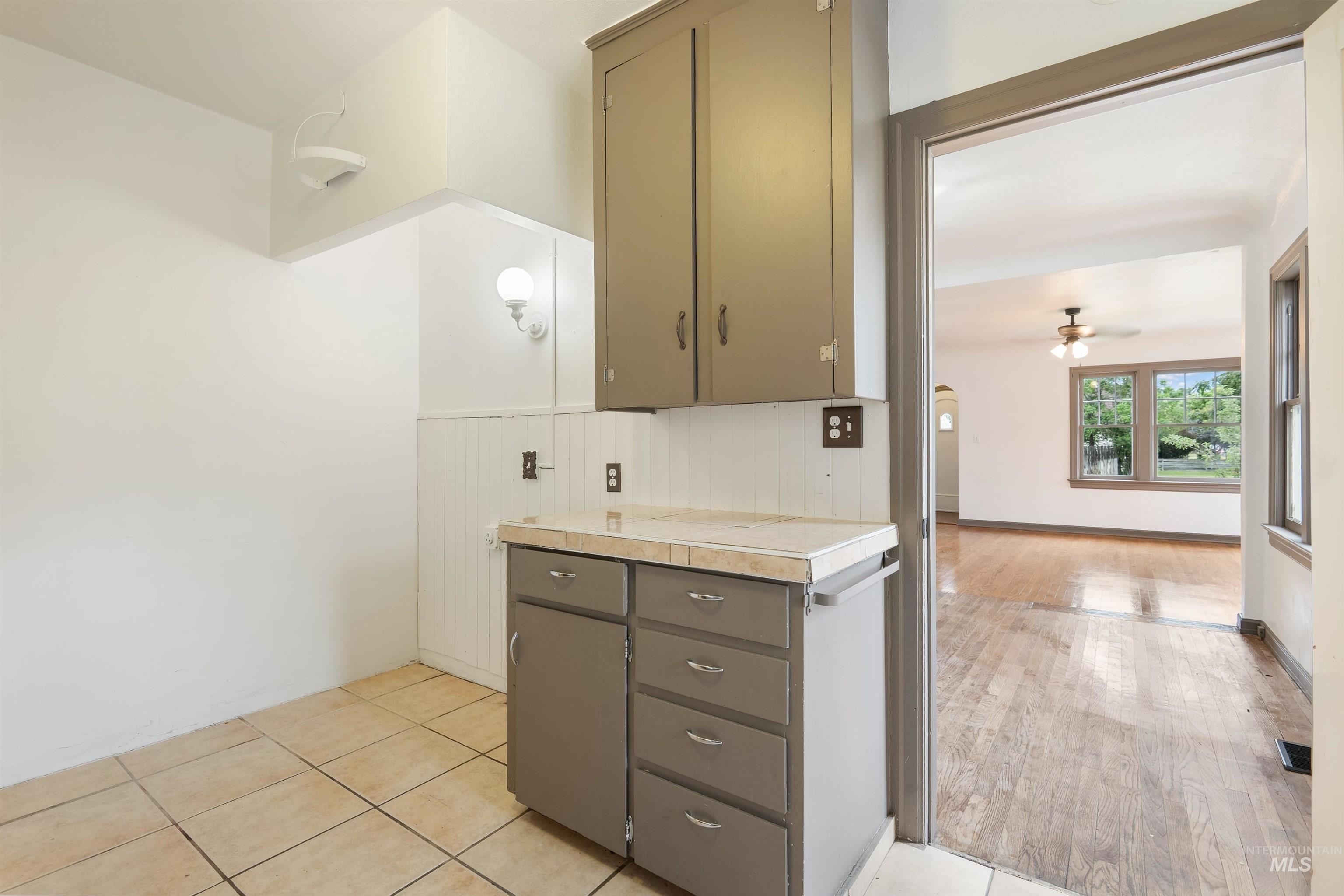 191 Southwest 5th Avenue Ontario, OR 97914 - Photo 21 of 50 Kitchen with ceiling fan, gray cabinetry, and light tile patterned flooring