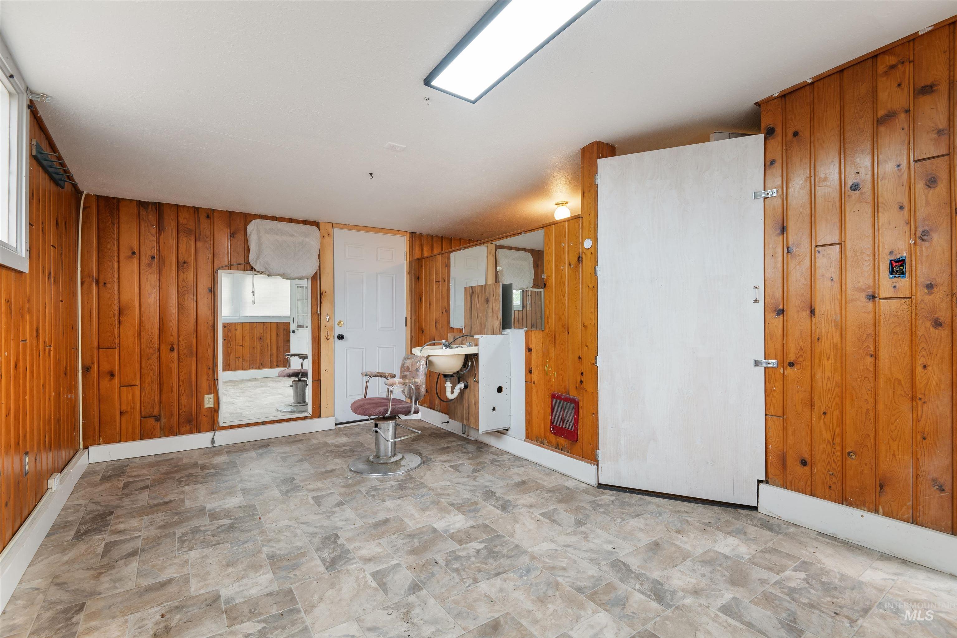 191 Southwest 5th Avenue Ontario, OR 97914 - Photo 31 of 50 Spare room featuring wooden walls, stone finish floors, and heating unit