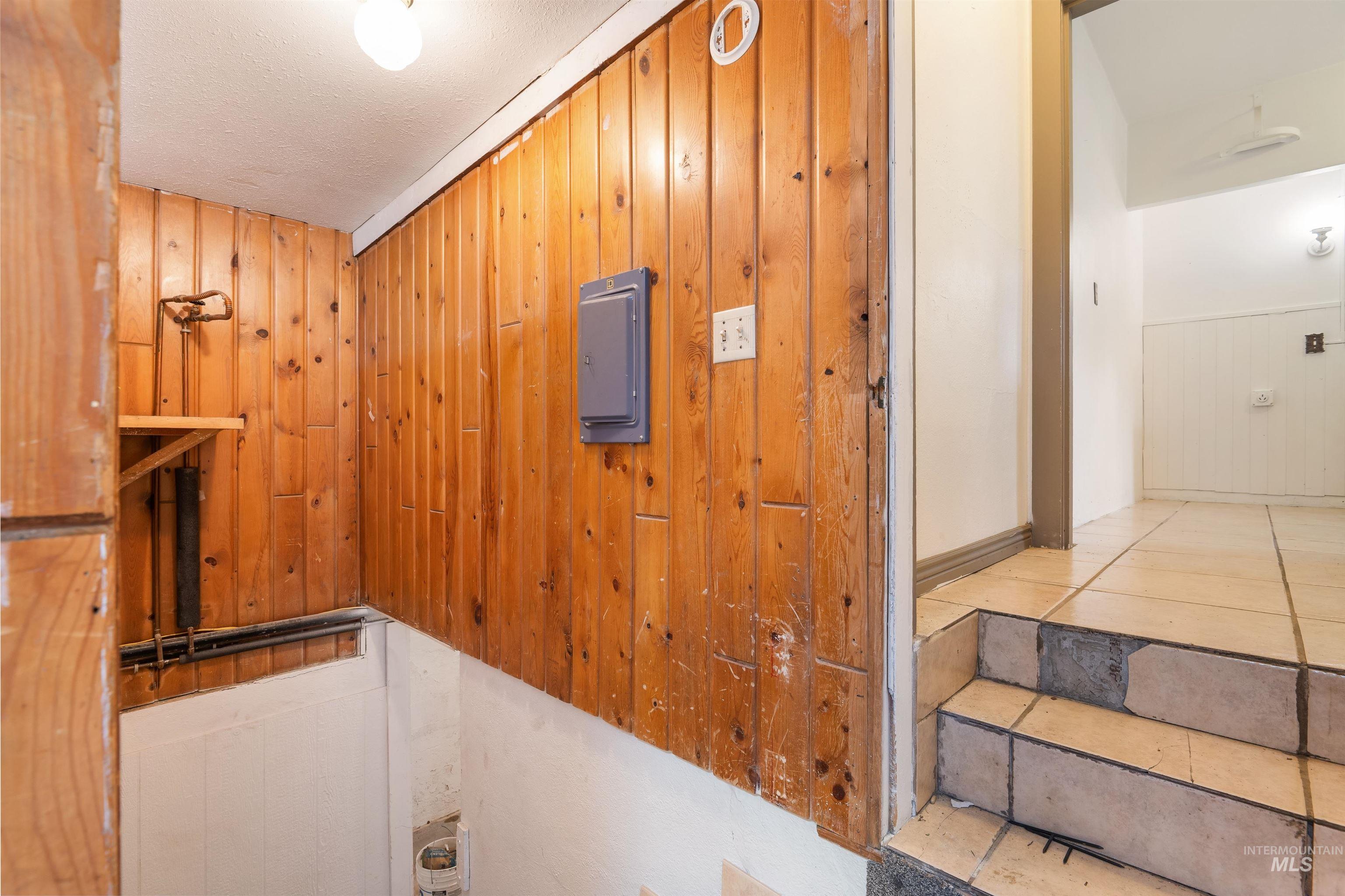 191 Southwest 5th Avenue Ontario, OR 97914 - Photo 33 of 50 Detailed view of wood walls, a textured ceiling, and electric panel