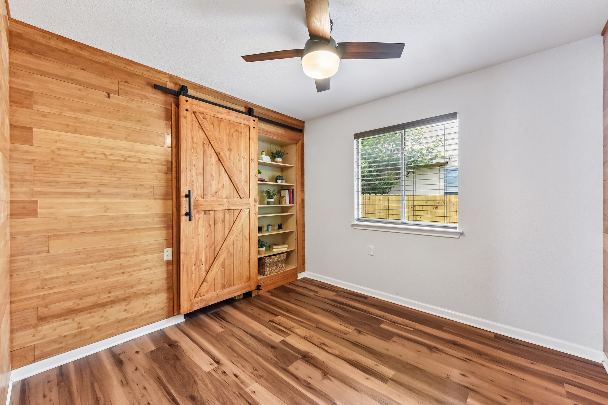 5405 Rusk Court Austin, TX 78723 - Photo 27 of 40 Secondary Bedroom 1: Behind the barn door is a closet space.