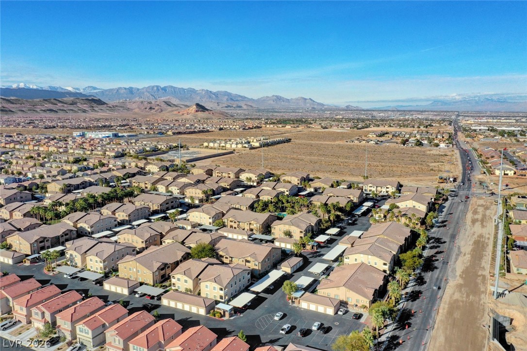 8985 South Durango Drive, Unit 2187 Las Vegas, NV 89113 - Photo 39 of 73 An aerial perspective reveals a vast community development against a mountainous desert backdrop.