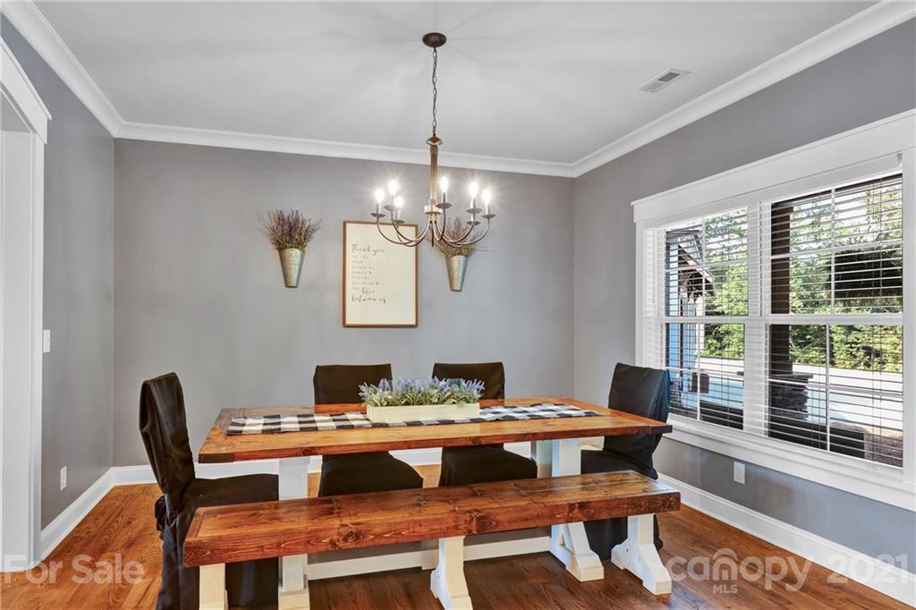 120 Agner Road Salisbury, NC 28146 - Photo 11 of 48 a view of a dining room with furniture wooden floor and a chandelier