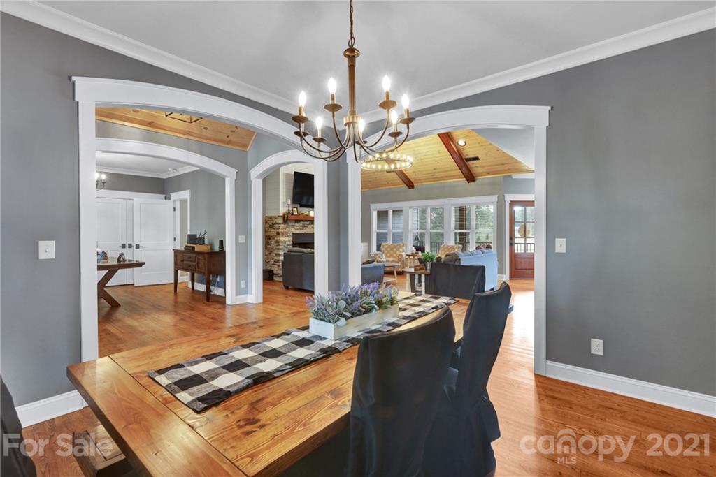 120 Agner Road Salisbury, NC 28146 - Photo 12 of 48 a dining room with wooden floor a chandelier a wooden table and chairs