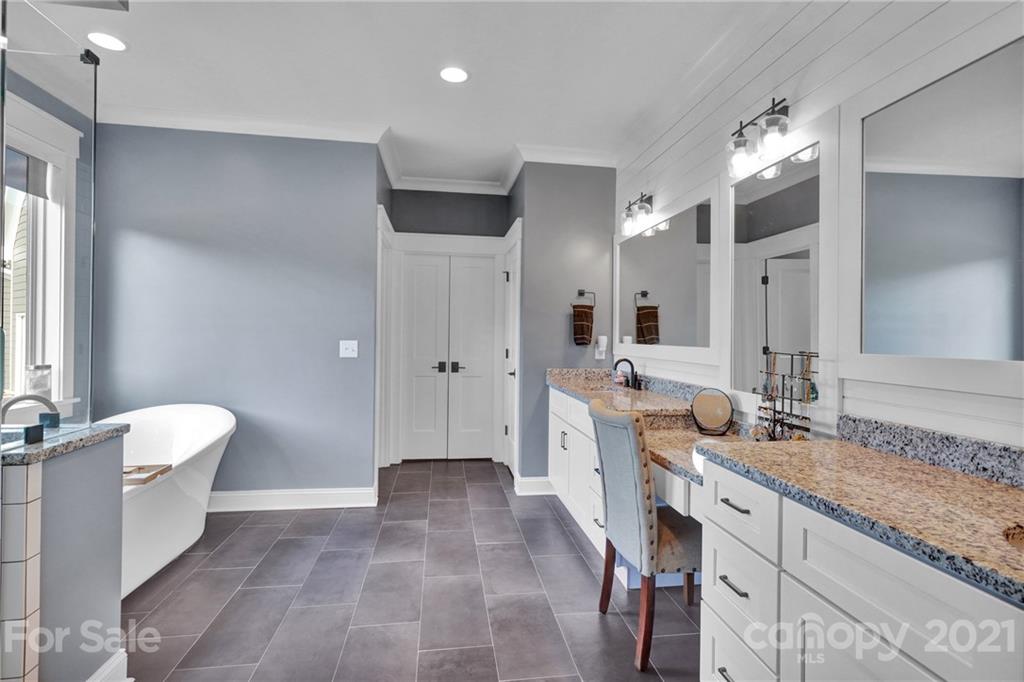 120 Agner Road Salisbury, NC 28146 - Photo 29 of 48 a spacious bathroom with a granite countertop sink a toilet a mirror and shower