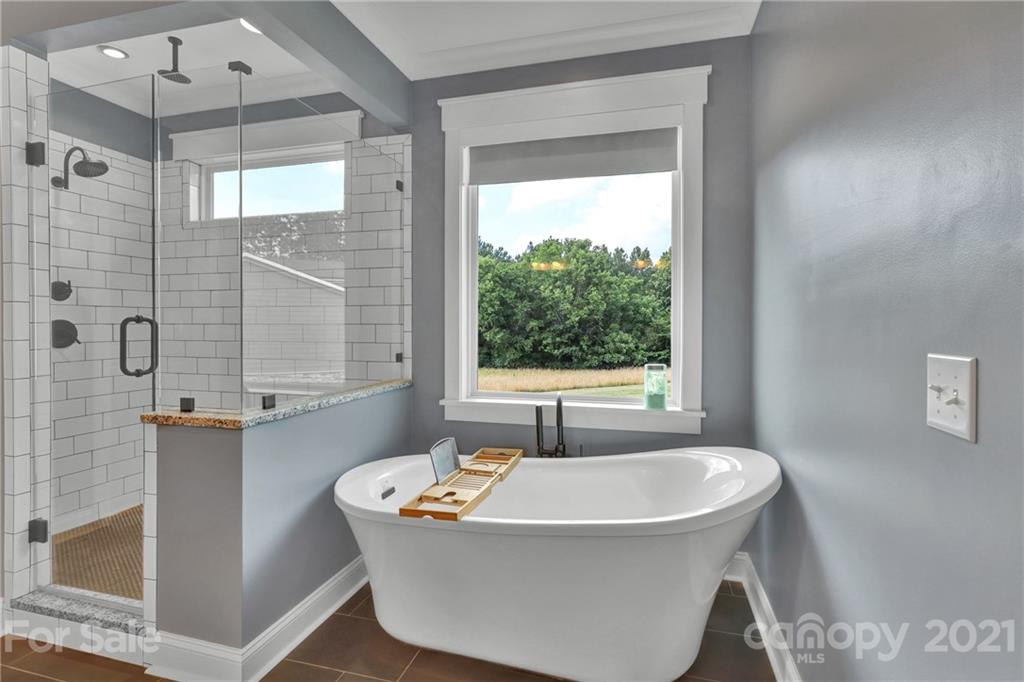 120 Agner Road Salisbury, NC 28146 - Photo 32 of 48 a white bath tub sitting in a bathroom next to a window