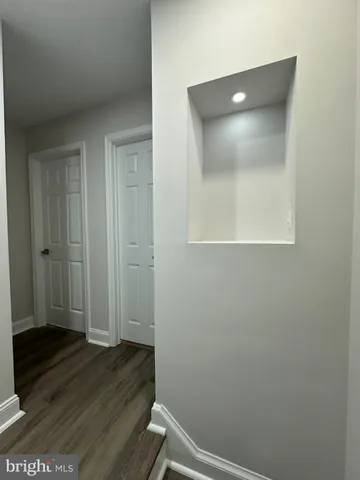 an empty room with wooden floor and closet