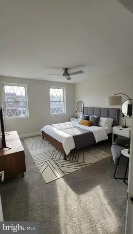 a bedroom with bed couch and window