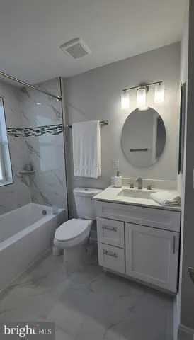 a bathroom with a toilet a sink and bathtub