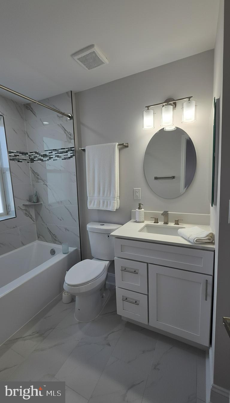 1742 Lyman Place Northeast Washington, DC 20002 - Photo 18 of 30 a bathroom with a toilet a sink and bathtub