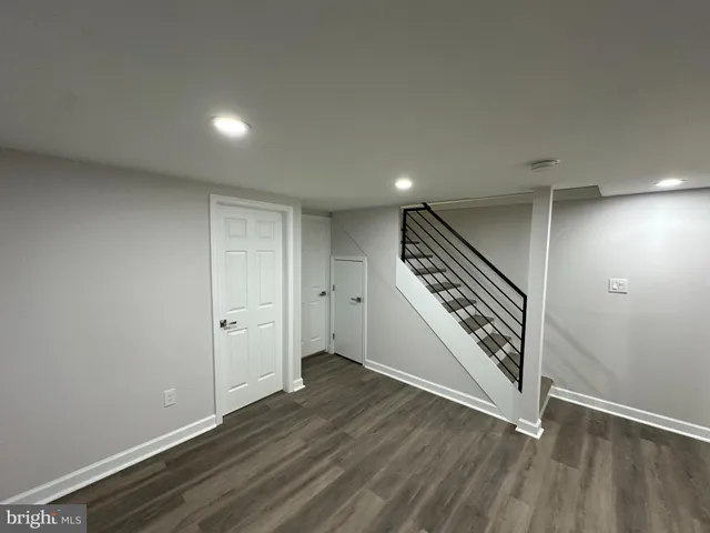 an entryway in a hall with wooden floor