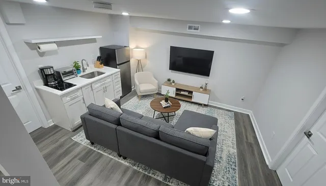 a living room with furniture and a flat screen tv