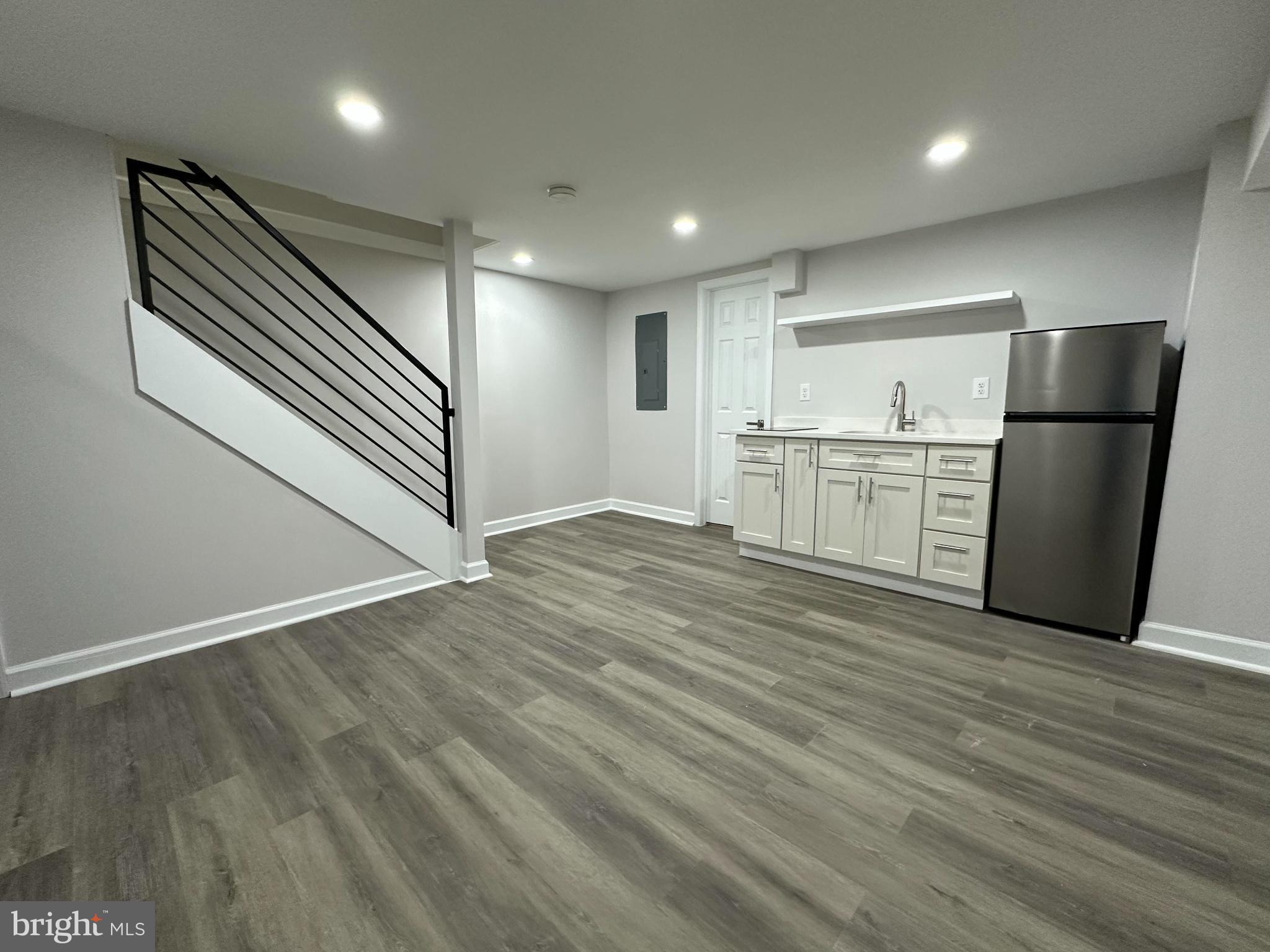 1742 Lyman Place Northeast Washington, DC 20002 - Photo 23 of 30 an empty room with wooden floor cabinet and windows
