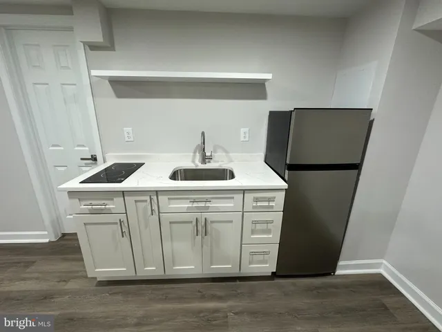 a kitchen with a sink and a refrigerator