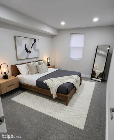 a bedroom with a bed and a couch