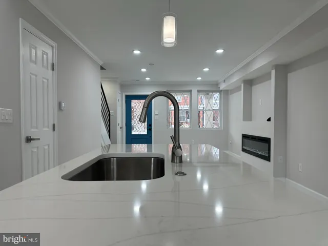 a kitchen with a sink and chandelier