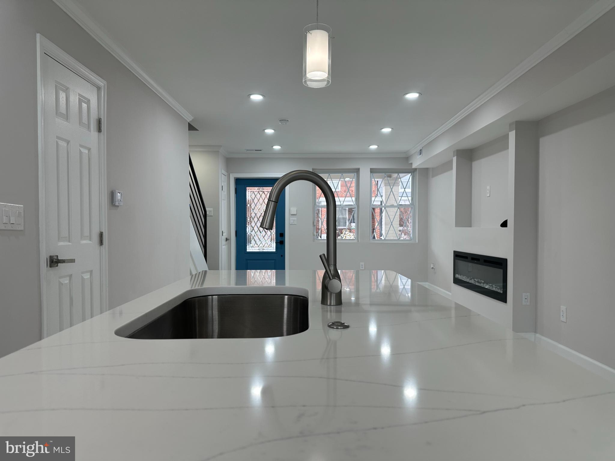 1742 Lyman Place Northeast Washington, DC 20002 - Photo 3 of 30 a kitchen with a sink and chandelier