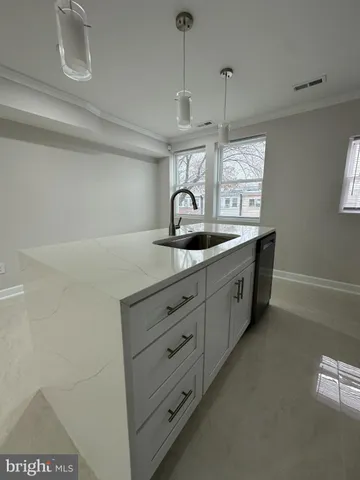 a kitchen with cabinets and window