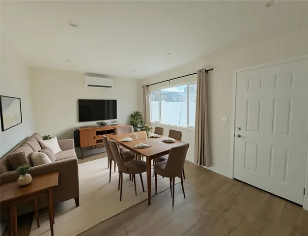 a view of a livingroom with furniture and a flat screen tv