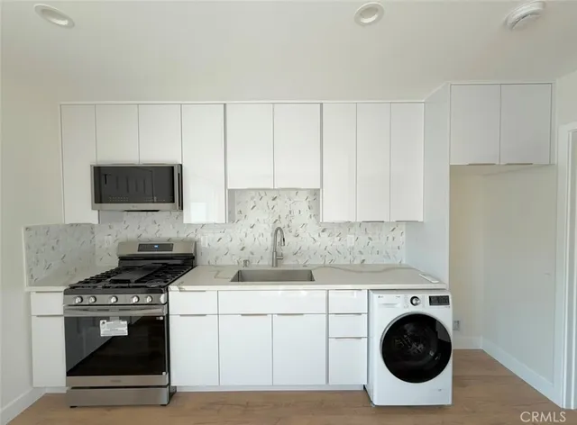 a kitchen with cabinets stainless steel appliances and wooden cabinets