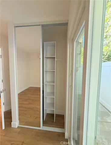 a view of walk in closet with empty room