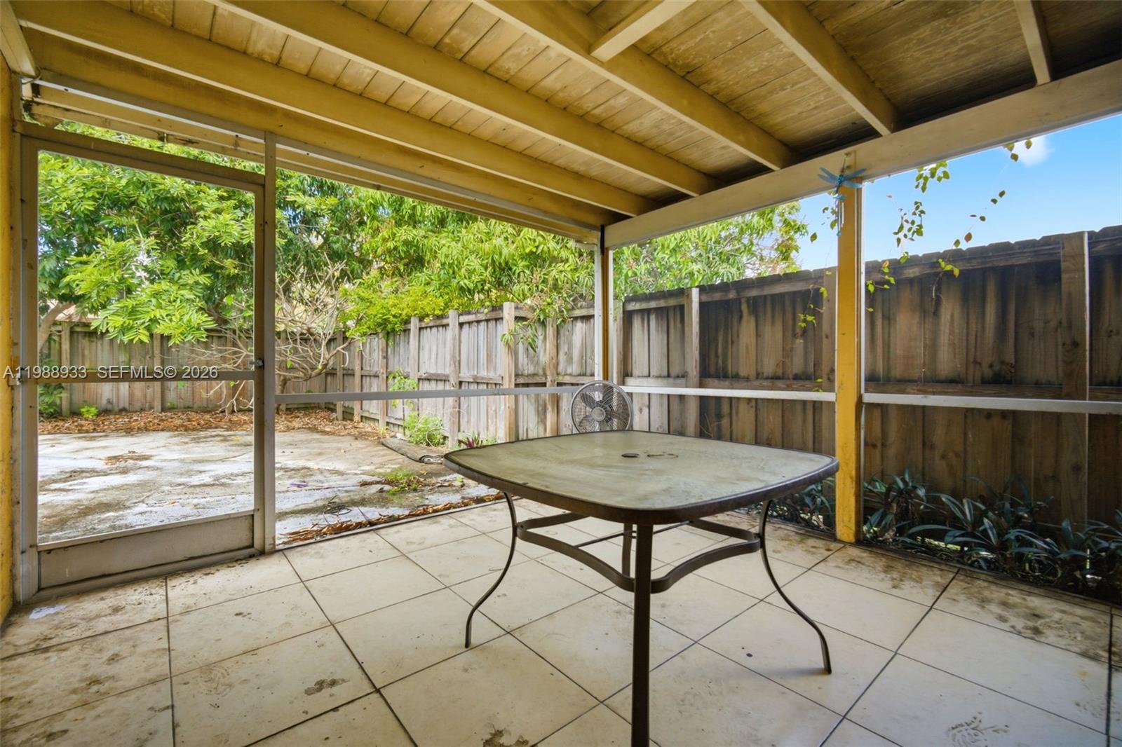 841 Southwest 55th Avenue Margate, FL 33068 - Photo 15 of 26 a view of a backyard with table and chairs and wooden floor
