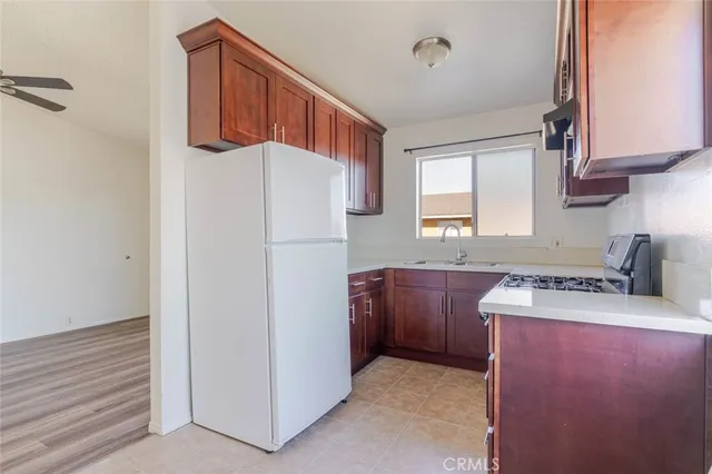a kitchen with a refrigerator and a sink