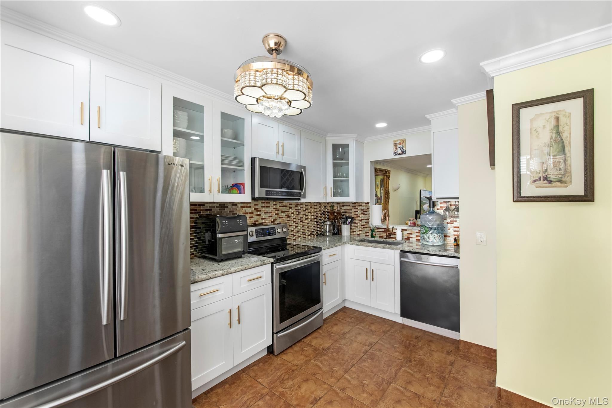 79 Creekside Circle Spring Valley, NY 10977 - Photo 5 of 13 a kitchen with stainless steel appliances granite countertop a refrigerator sink and stove