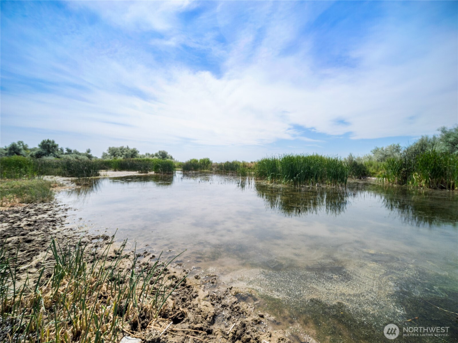 8708 Rd K Northeast Moses Lake, WA 98837 - Photo 33 of 40 a view of a lake with houses in the back