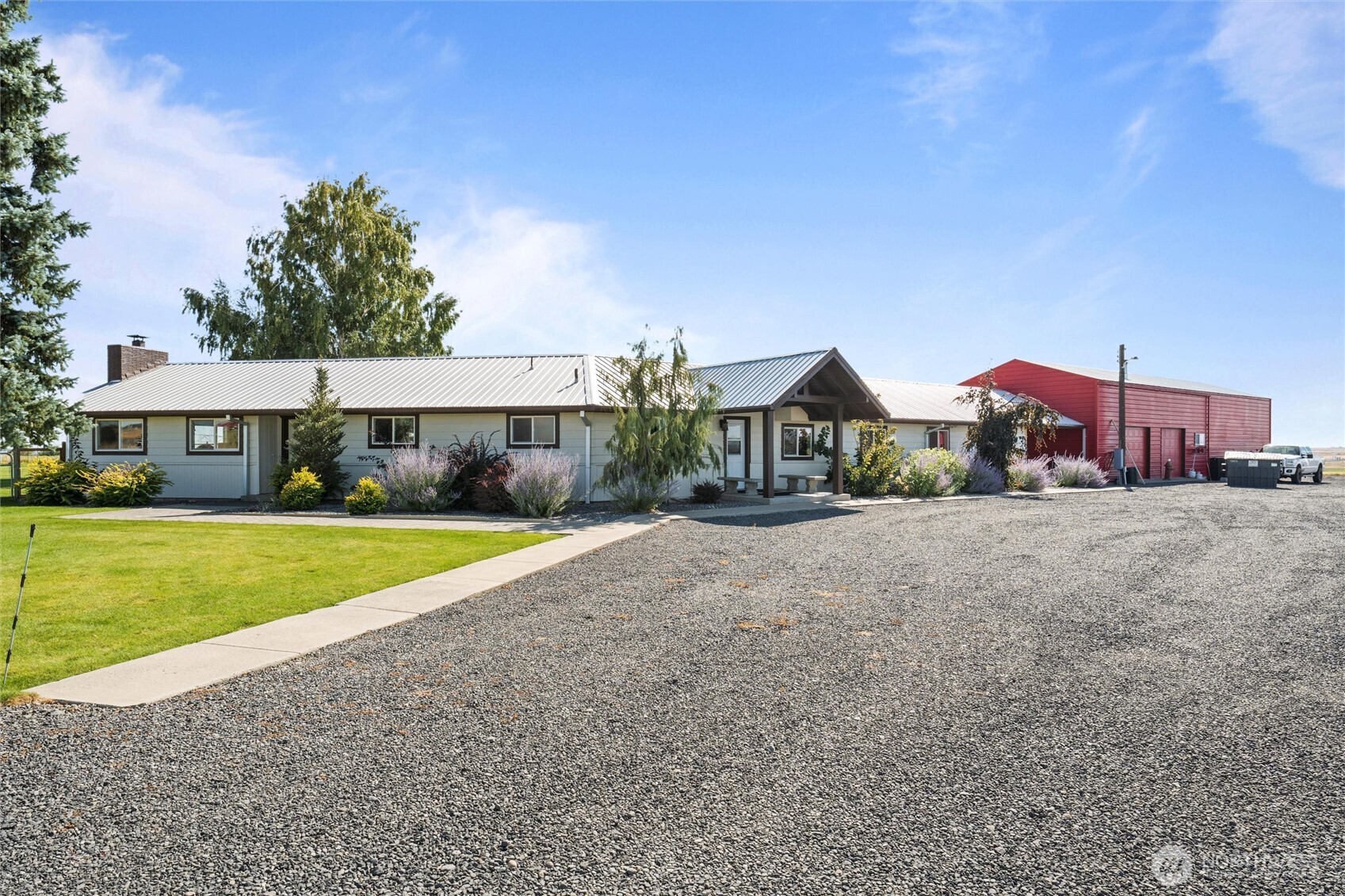 8708 Rd K Northeast Moses Lake, WA 98837 - Photo 6 of 40 a front view of a house with a yard and garage