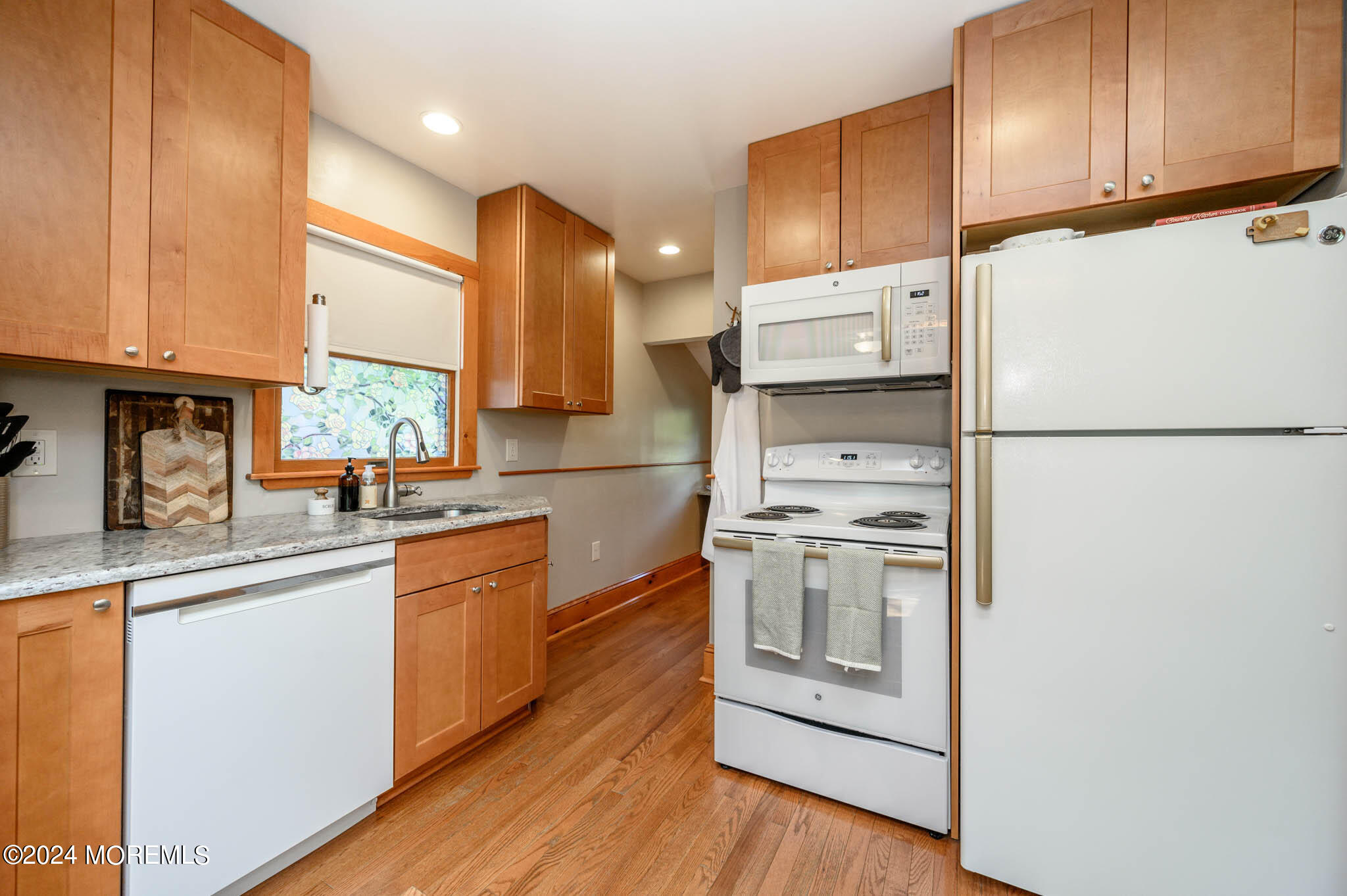 13 Oliver Street Toms River, NJ 08755 - Photo 12 of 41 a kitchen with white cabinets and white appliances