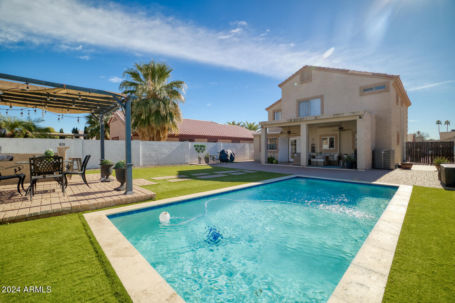 7340 West Ocotillo Road Glendale, AZ 85303 - Photo 29 of 45 a view of an house with swimming pool and chairs
