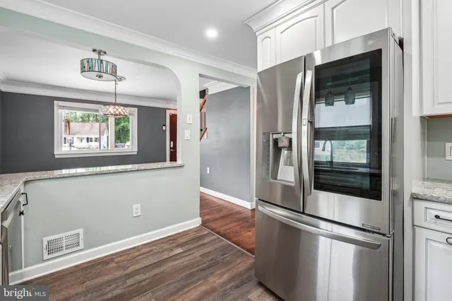 a kitchen with stainless steel appliances a refrigerator and a window