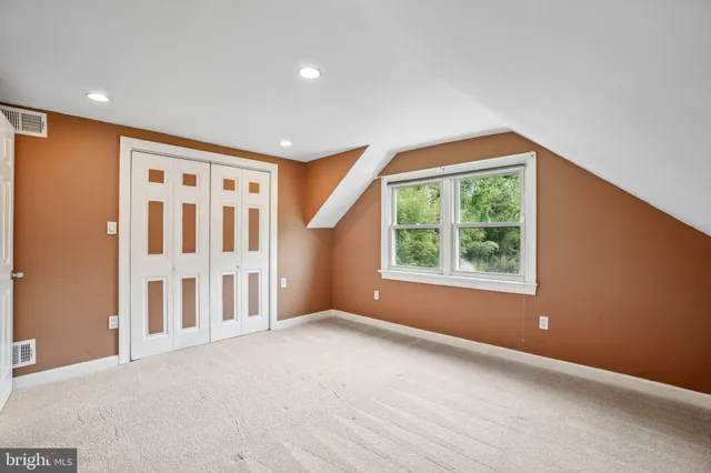 an empty room with windows and closet