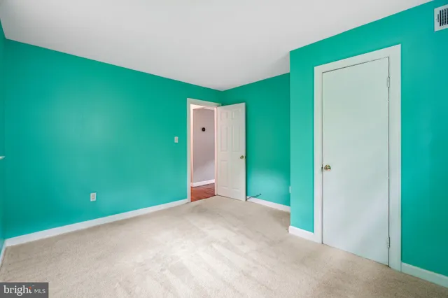 a view of a livingroom with wooden floor and stairs