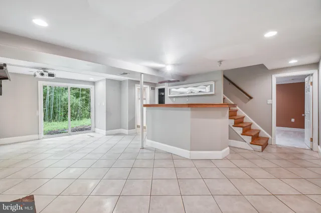 a kitchen with stainless steel appliances granite countertop a refrigerator a stove and a sink