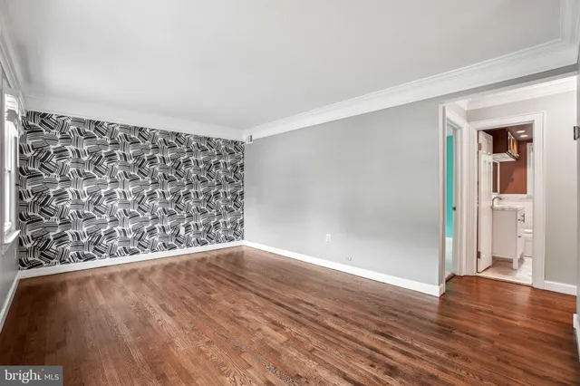 wooden floor in a hall with an empty room and wooden floor
