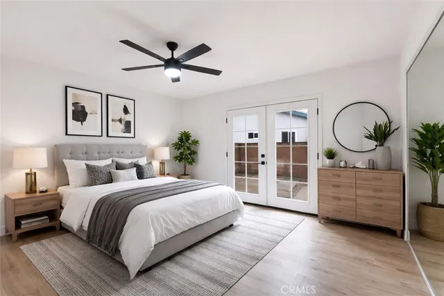 a bedroom with a large bed and a chandelier