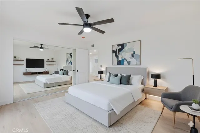 a bedroom with a large bed and a tv