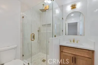 a bathroom with a shower sink vanity and mirror