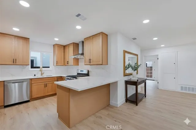 a large kitchen with stainless steel appliances granite countertop a sink and a stove