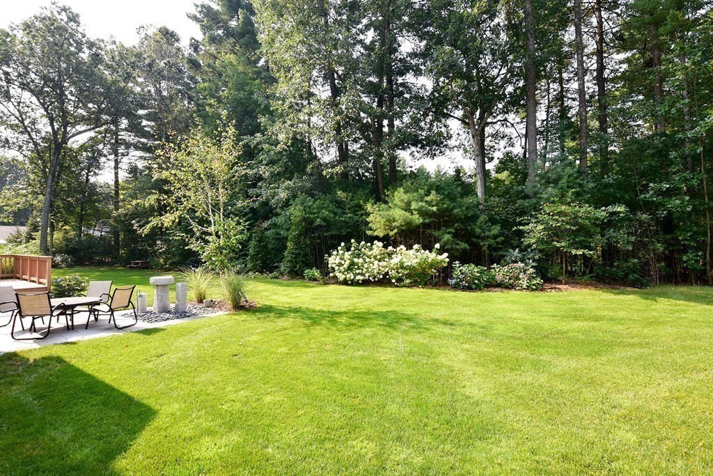 9 Nehemiah Road Shirley, MA 01464 - Photo 17 of 23 a backyard of a house with table and chairs