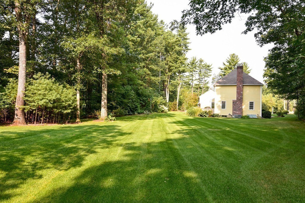 9 Nehemiah Road Shirley, MA 01464 - Photo 22 of 23 a garden with trees in front of it