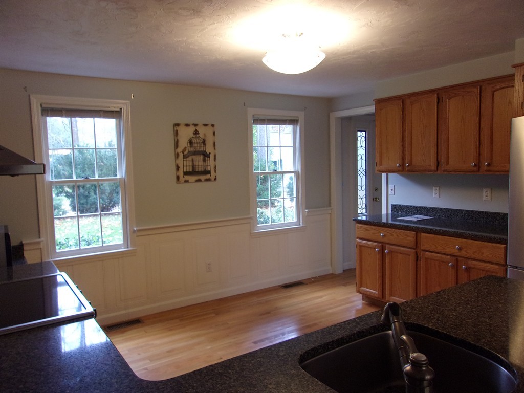 9 Nehemiah Road Shirley, MA 01464 - Photo 3 of 23 a kitchen with granite countertop wooden cabinets and a stove top oven