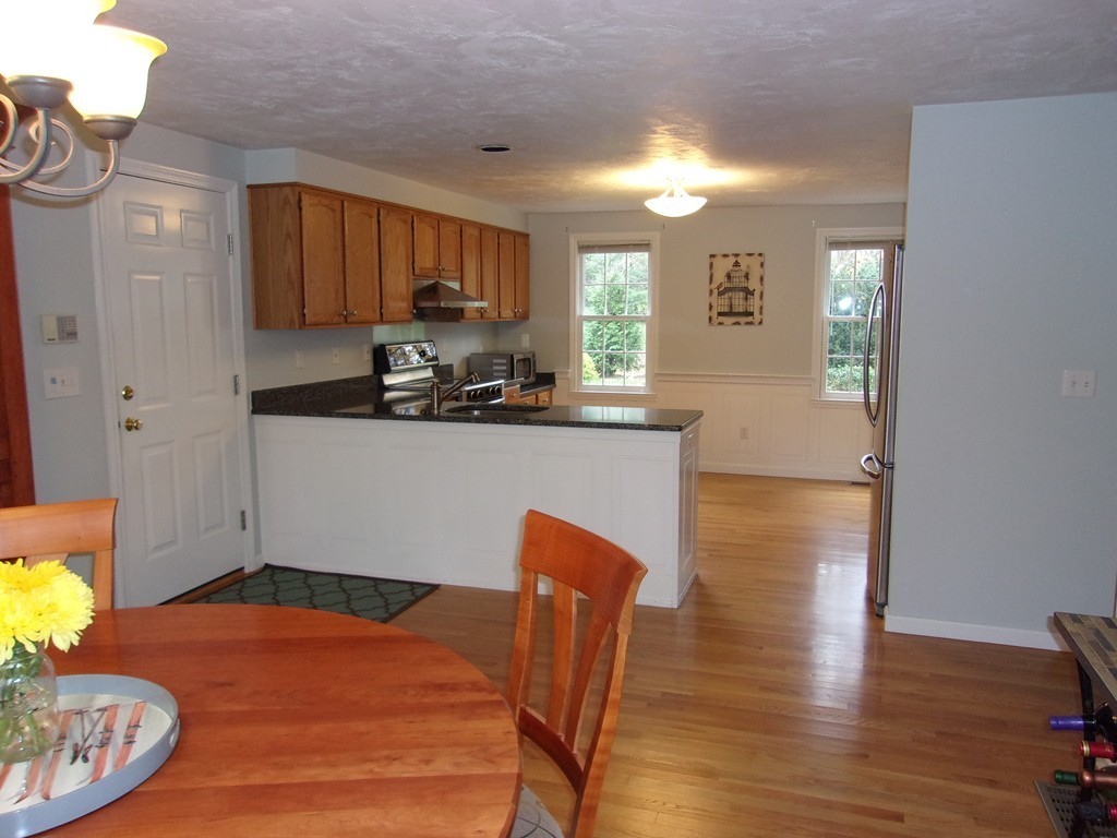 9 Nehemiah Road Shirley, MA 01464 - Photo 4 of 23 a kitchen with granite countertop a sink cabinets and wooden floor