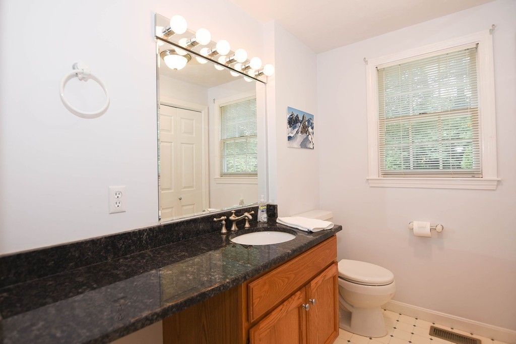 9 Nehemiah Road Shirley, MA 01464 - Photo 10 of 23 a bathroom with a granite countertop sink a toilet and a mirror