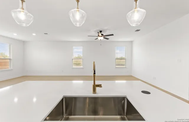 a view of a kitchen with a sink and chandelier