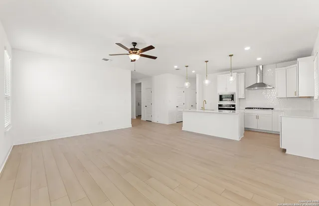 a view of a kitchen with a sink and a refrigerator