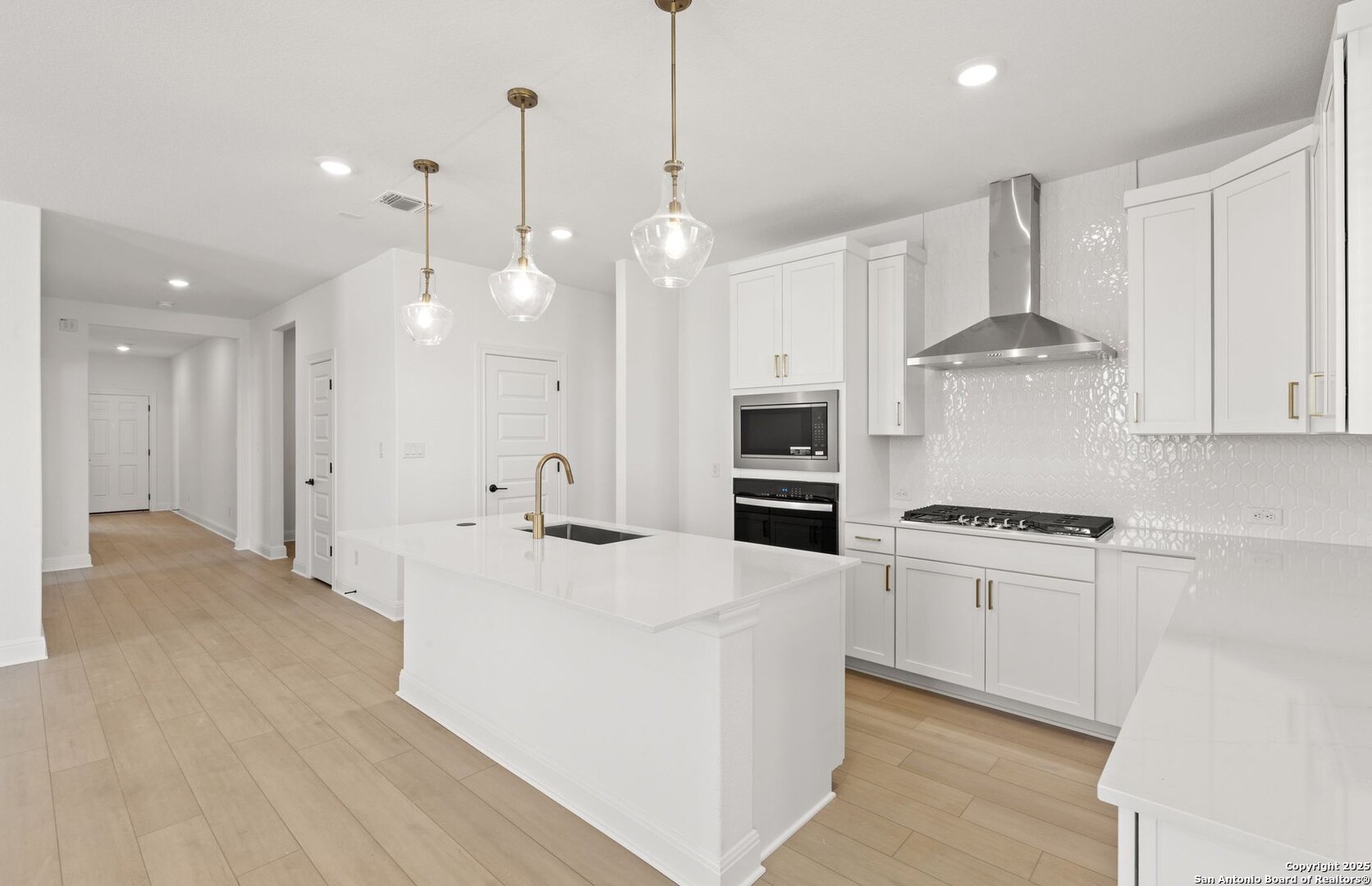 438 Nightingale Avenue Marion, TX 78124 - Photo 16 of 32 a kitchen with stainless steel appliances a stove a sink a refrigerator and white cabinets