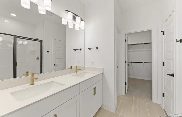 a bathroom with a double vanity sink mirror and double